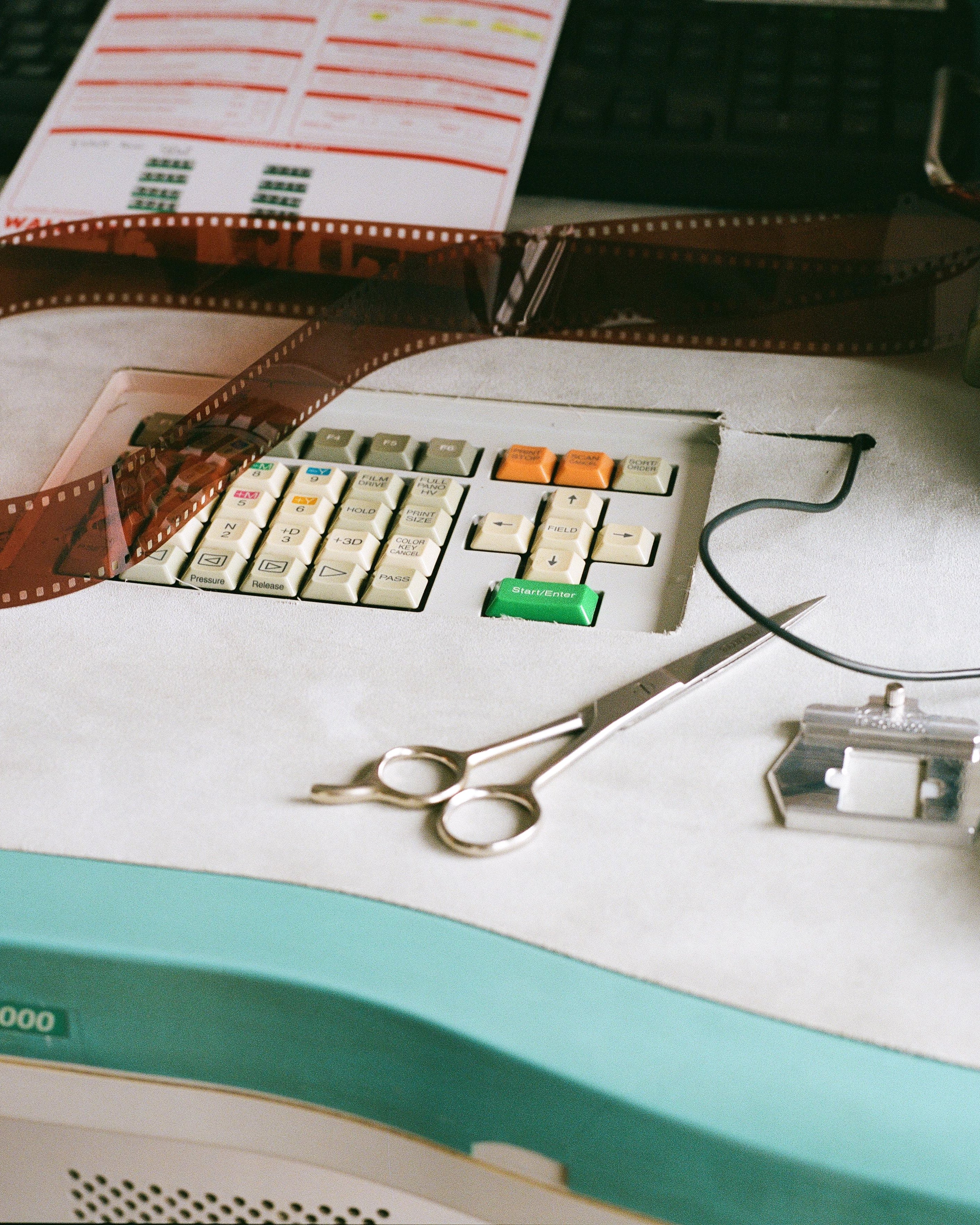 Film reel, keyboard, scissors on a desk